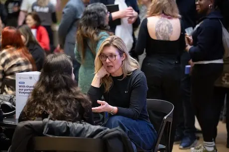 Attendees deep in discussion during a break.